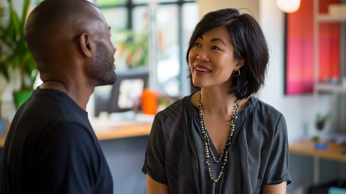 Small business owner having a genuine engagement conversation with a team member in a modern office setting