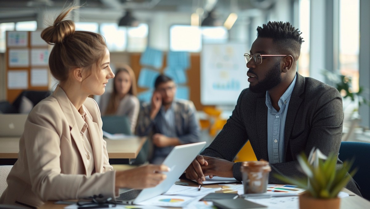 Sales and operations professionals collaborating over business data in modern office setting representing cross-functional alignment